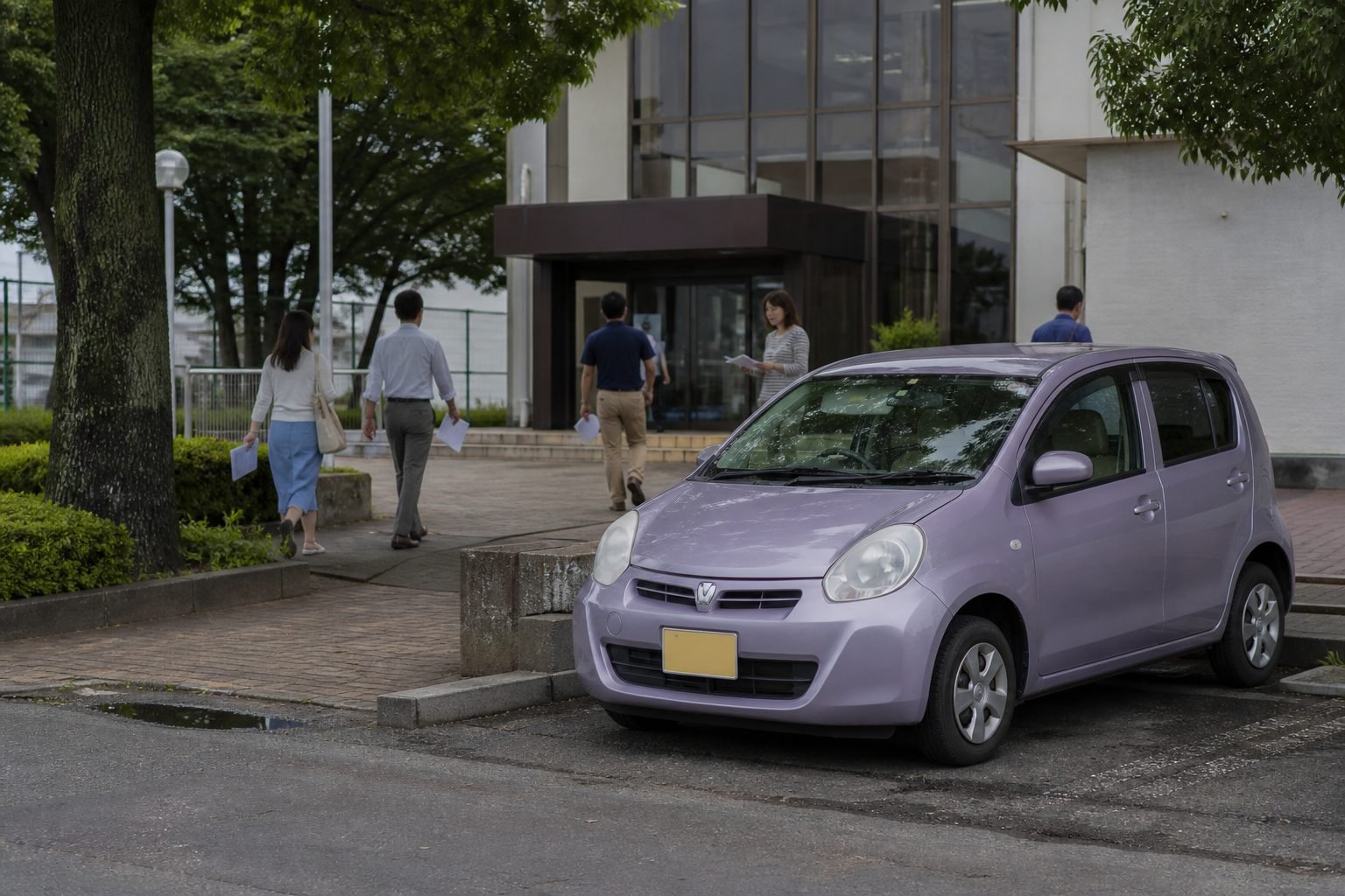 Compact car parked outside a Japanese municipal office while owners carry document folders